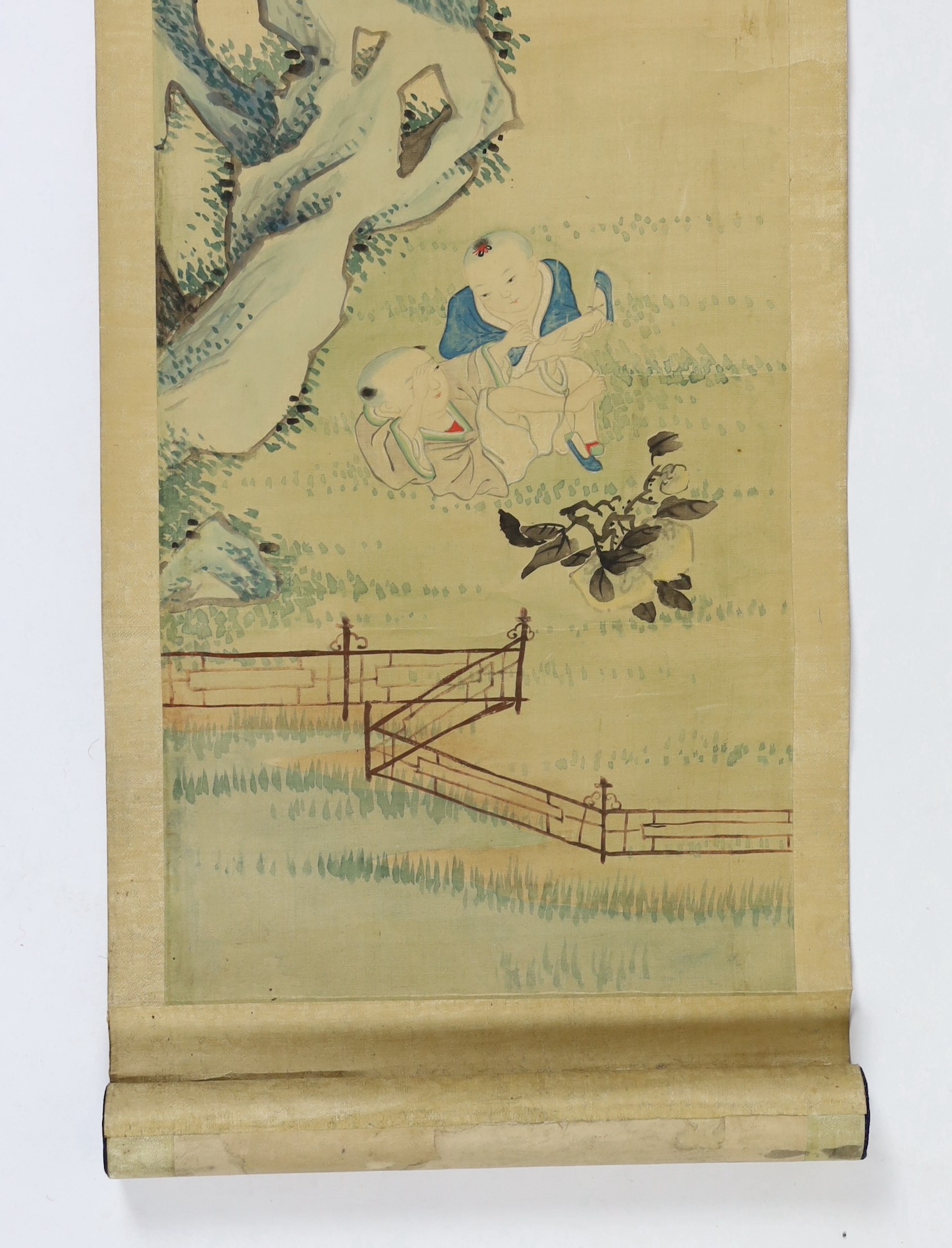 A Chinese scroll painting on silk of a mother watching her children play in a garden, 19th century, image 95cm x 21cm